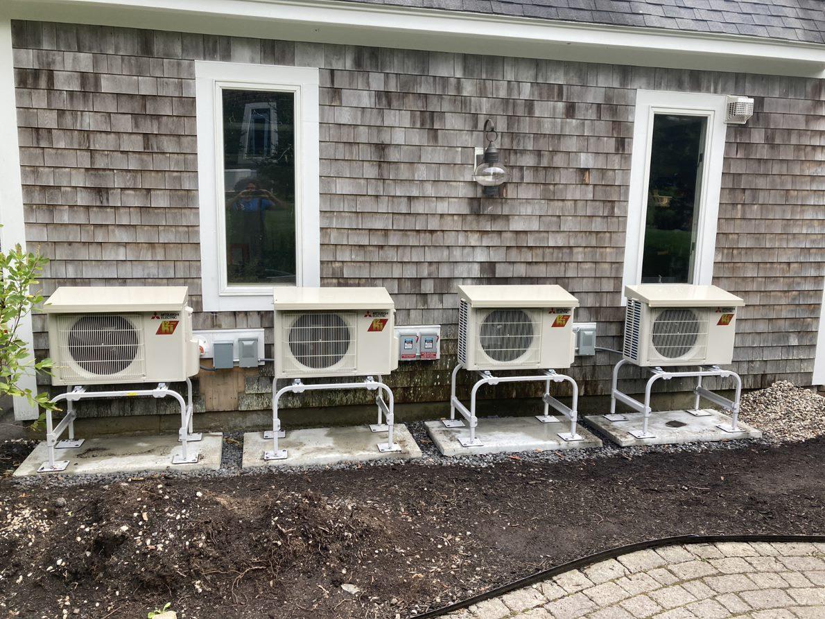 Four outdoor Mitsubishi heat pump units